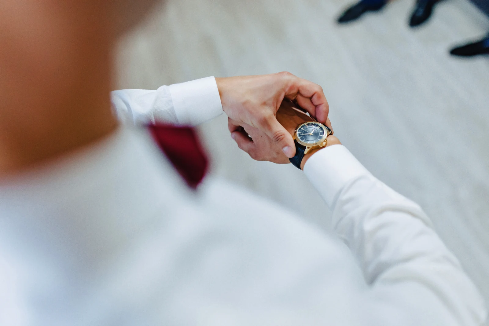 Man checking the fit and time of a watch on his wrist